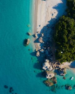 Turquoise coastline seen from above, the open-water setting for Guerlain's Longeviskin retreat at sea